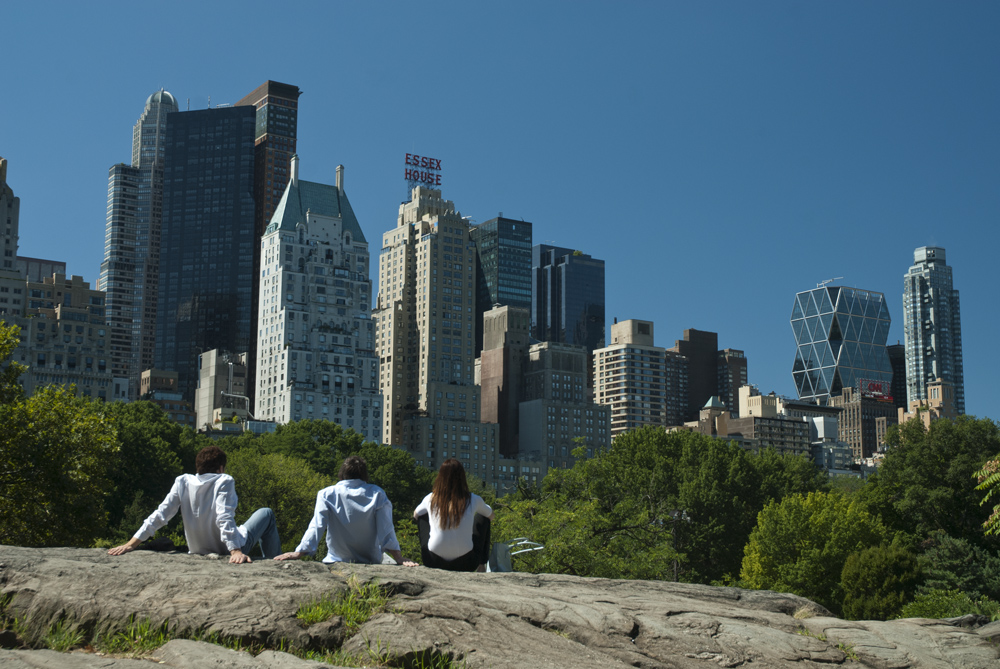 3 people relaxing in the urban oasis that Central Park is, New York City, US.